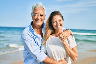 hugging happy couple at windy beach three core principles 4l financial llc illinois