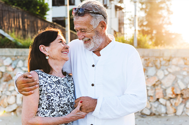 smiling couple on beach vacation retirement strategies 4l financial llc illinois